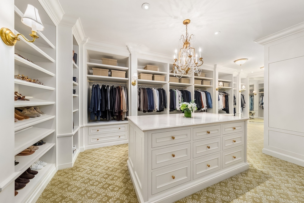 180 Ash Street Weston, MA 02493 - Photo 21 of 39 a room with kitchen island a chandelier and a view of living room