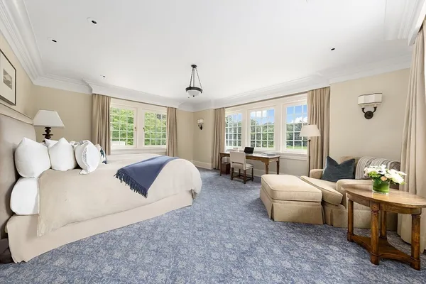 a bed room with a bed and a large window