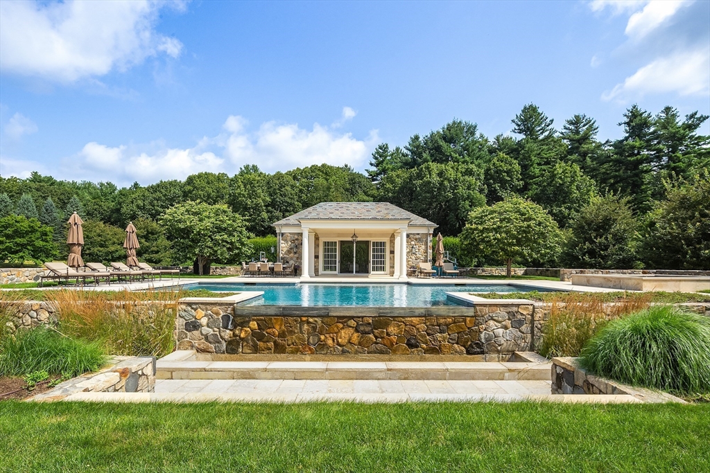 180 Ash Street Weston, MA 02493 - Photo 3 of 39 a front view of a house with swimming pool having outdoor seating