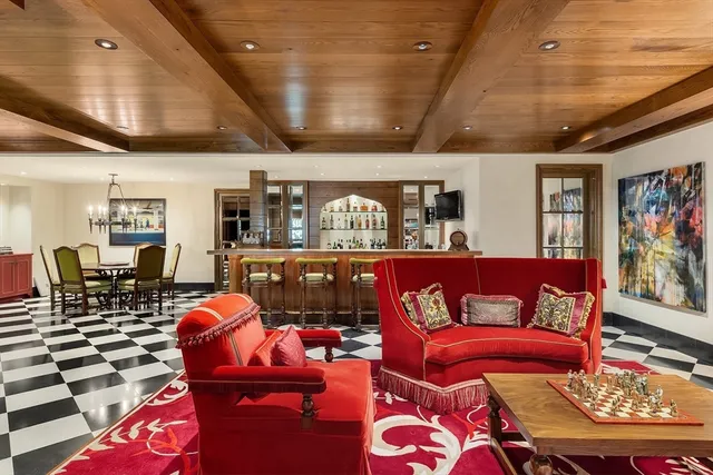 a living room with furniture a rug and a chandelier