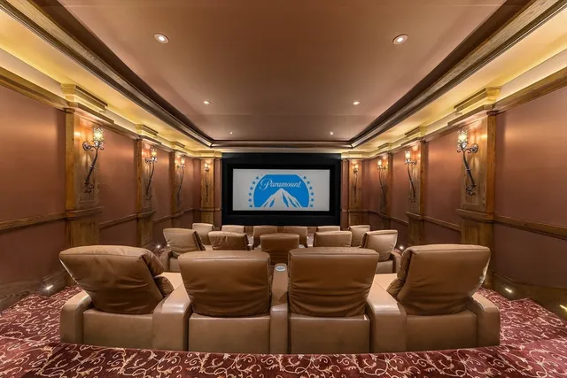 a media room with lots of chairs and a projector screen