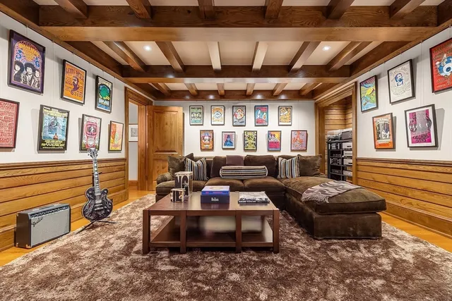 a living room with furniture a couch and paintings on the wall