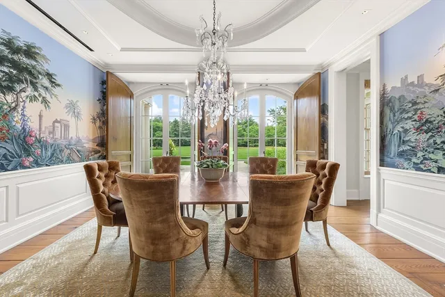 a view of a dining room with furniture wooden floor and chandelier