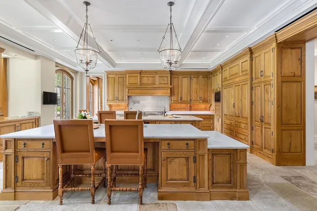 a kitchen with a table chairs refrigerator and cabinets