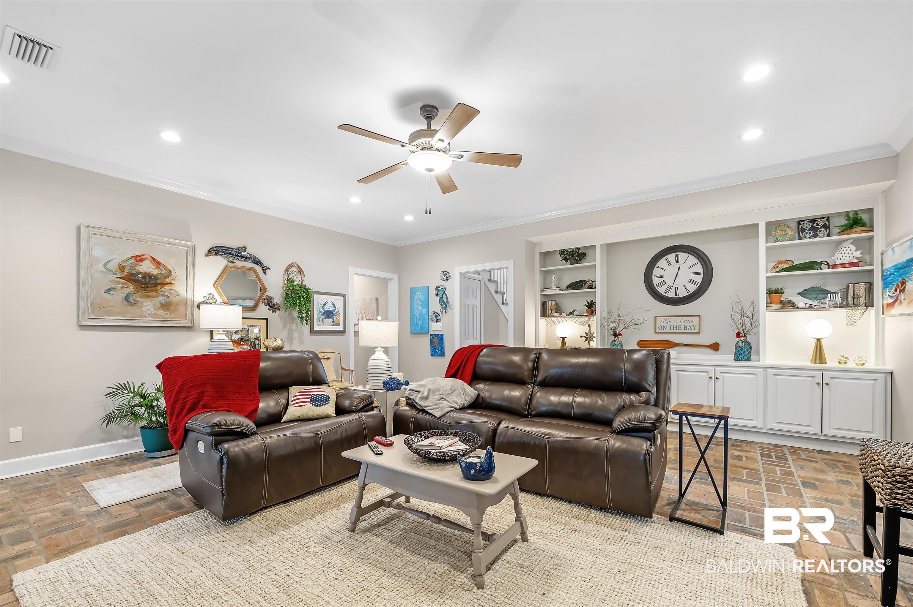 8915 Bay Point Drive Elberta, AL 36530 - Photo 16 of 74 Living room featuring baseboards, visible vents, crown molding, and recessed lighting
