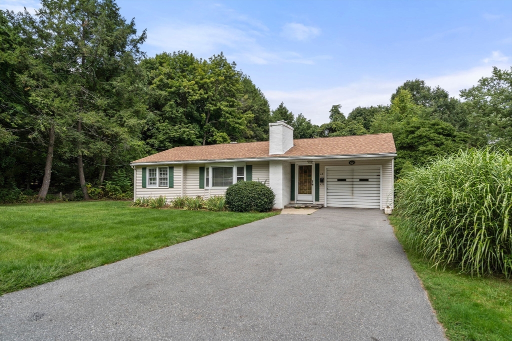 a view of a house with yard and a garden