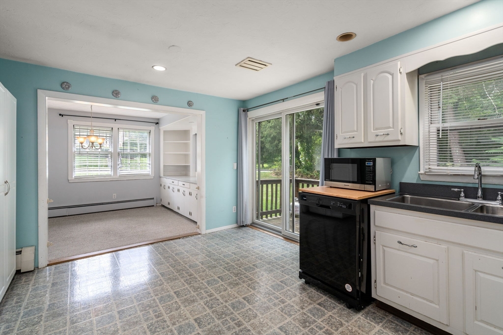62 Nelson Place Worcester, MA 01605 - Photo 11 of 33 a kitchen with granite countertop a stove a sink and a window