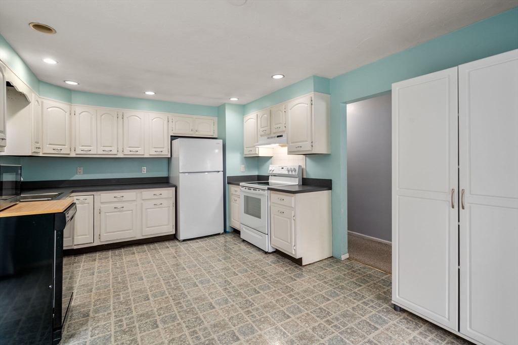 62 Nelson Place Worcester, MA 01605 - Photo 12 of 33 a kitchen with white cabinets and white appliances