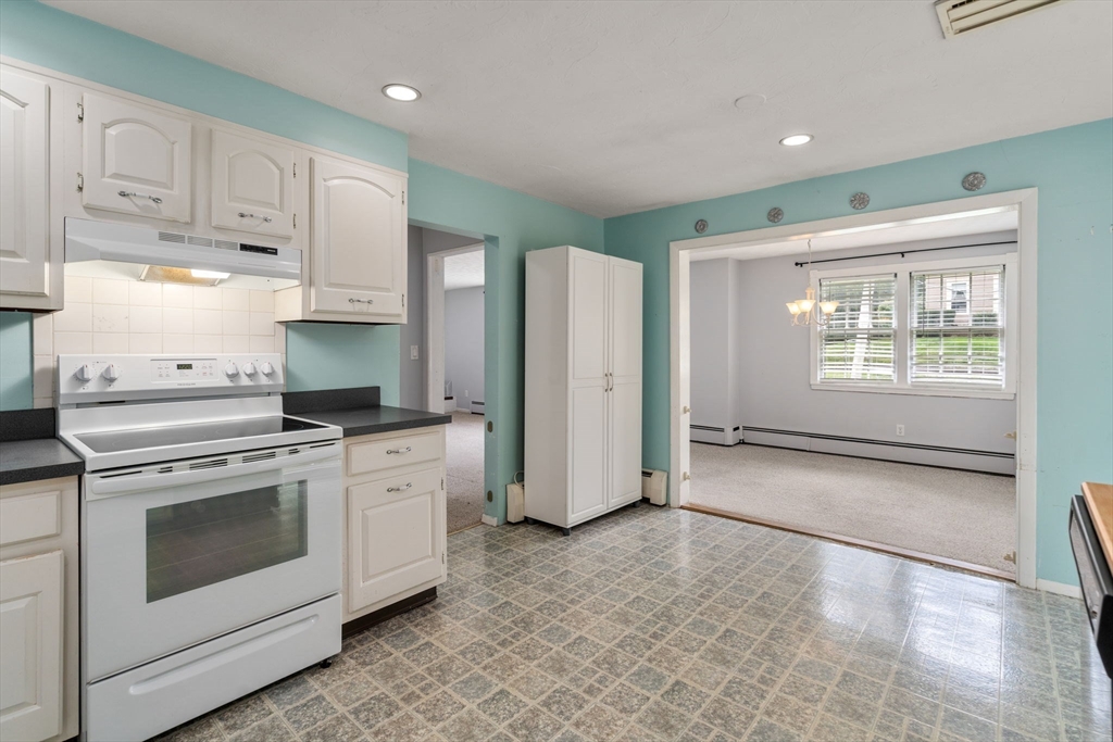 62 Nelson Place Worcester, MA 01605 - Photo 14 of 33 a kitchen with white cabinets and white appliances