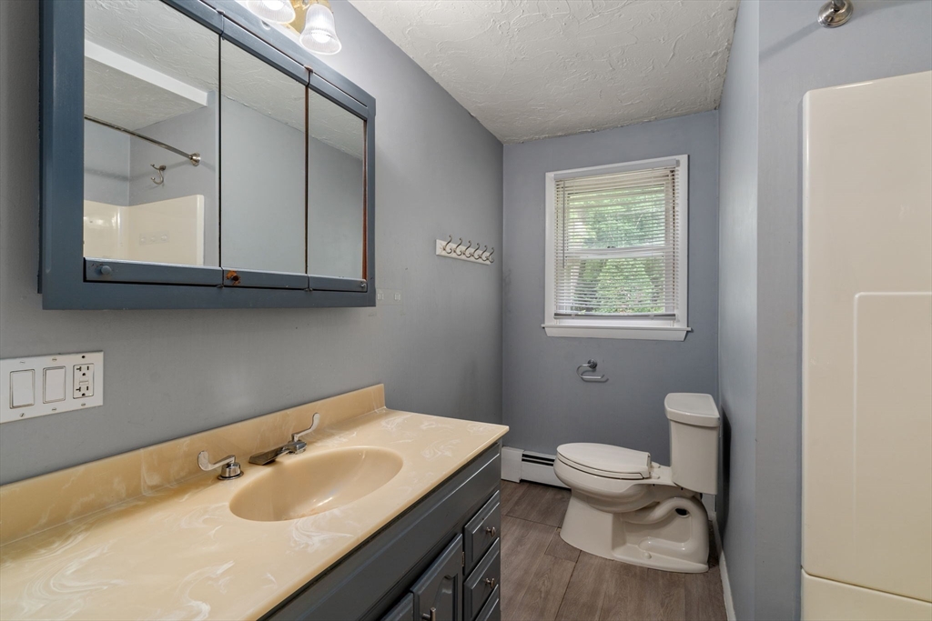 62 Nelson Place Worcester, MA 01605 - Photo 20 of 33 a bathroom with a sink toilet a mirror and vanity