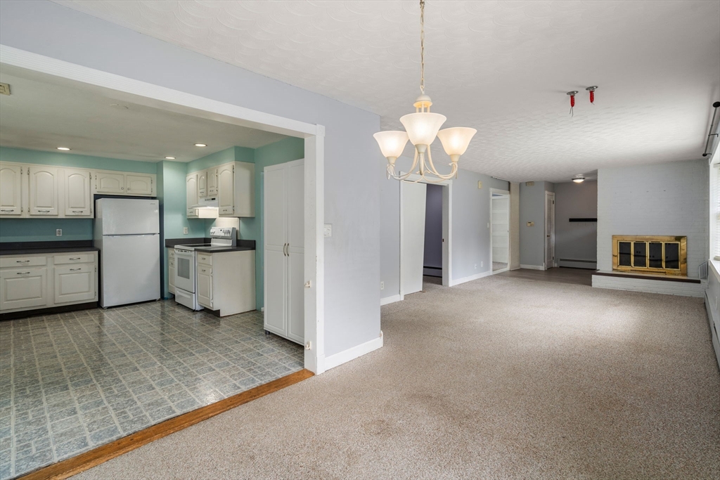 62 Nelson Place Worcester, MA 01605 - Photo 10 of 33 a view of a kitchen with a sink a refrigerator and a stove top oven