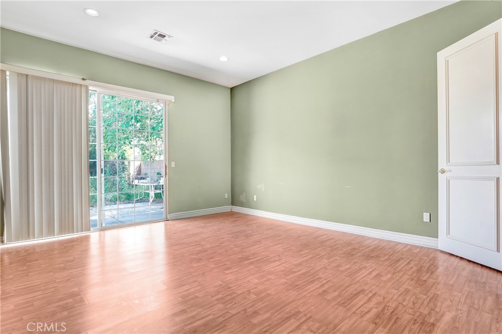 17919 Califa Street Encino, CA 91316 - Photo 8 of 11 a view of an empty room with wooden floor and a window