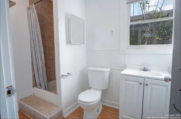 a bathroom with a toilet a sink and a window