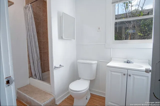 a bathroom with a toilet a sink and a window