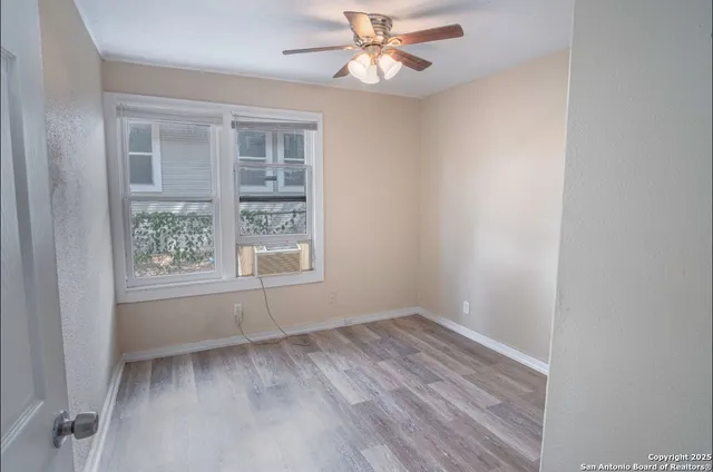 wooden floor in an empty room with a window