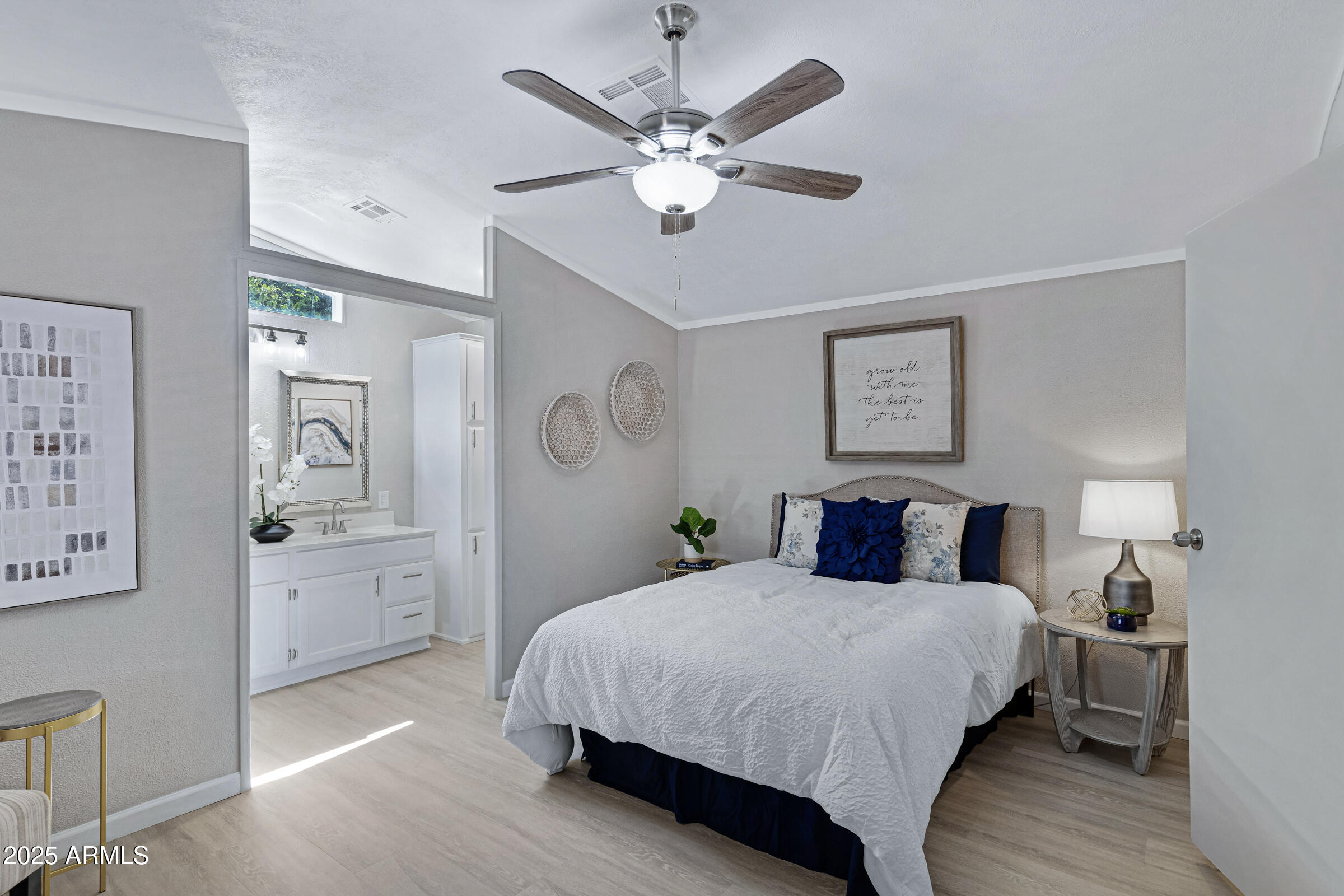 834 South Meridian Road, Unit 156 Apache Junction, AZ 85120 - Photo 10 of 20 a bedroom with a large bed and a chandelier