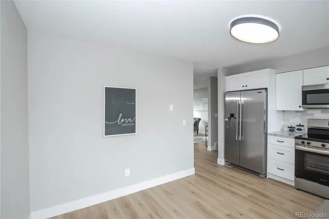 a view of a kitchen with a sink cabinets and wooden floor