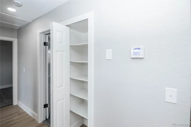a view of walk in closet with empty racks