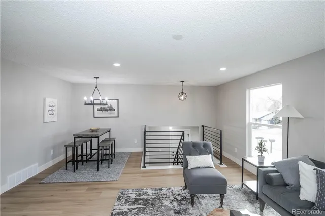 a bedroom with furniture and wooden floor