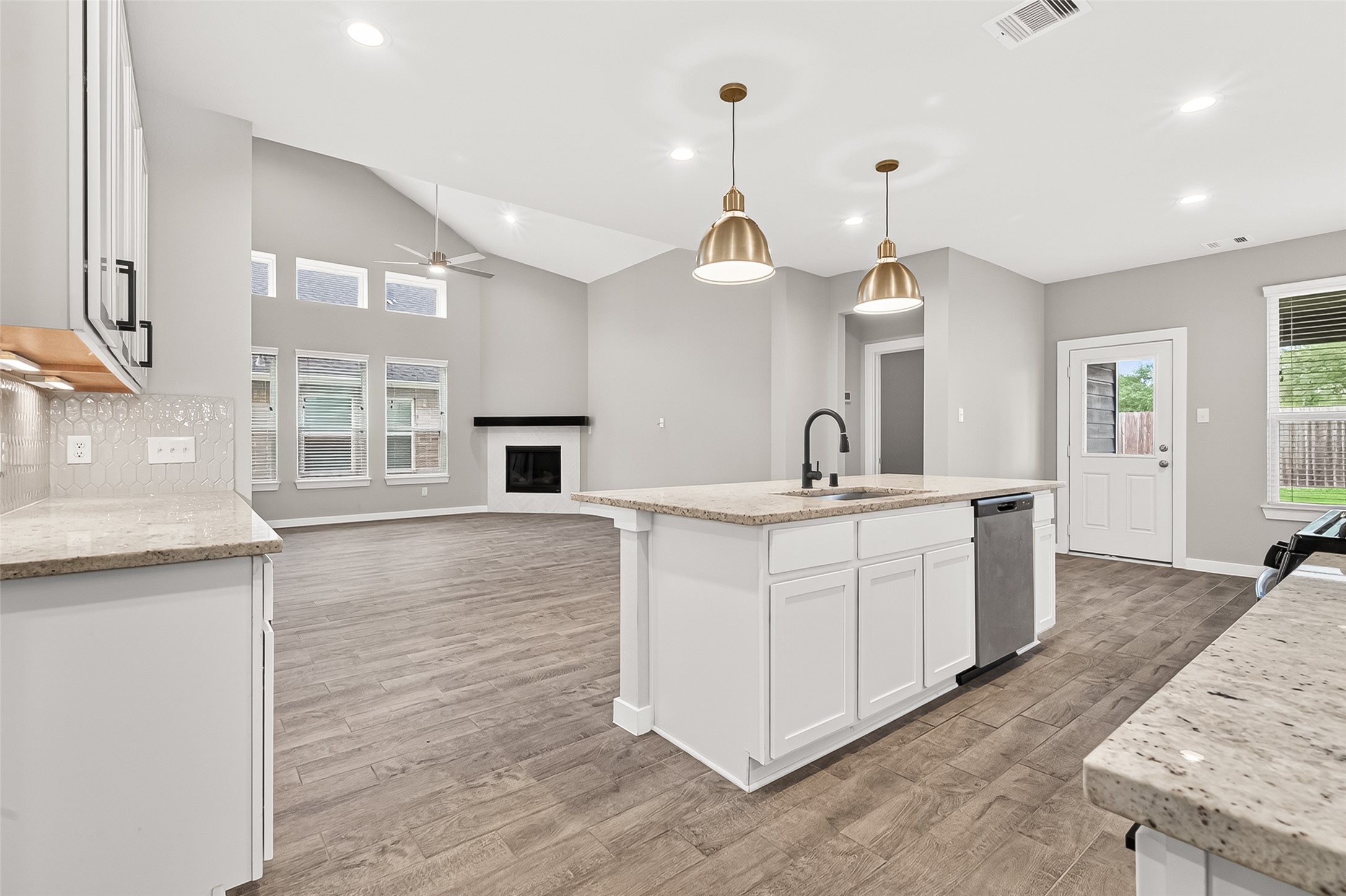 2142 Reed Cave Lane Spring, TX 77386 - Photo 16 of 50 a large kitchen with kitchen island a sink stainless steel appliances and a chandelier