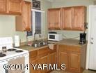 250 North Grey Road Grandview, WA 98930 - Photo 2 of 8 a view of kitchen with a sink and a wooden table
