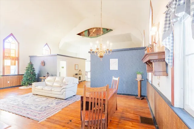a living room with furniture and a chandelier