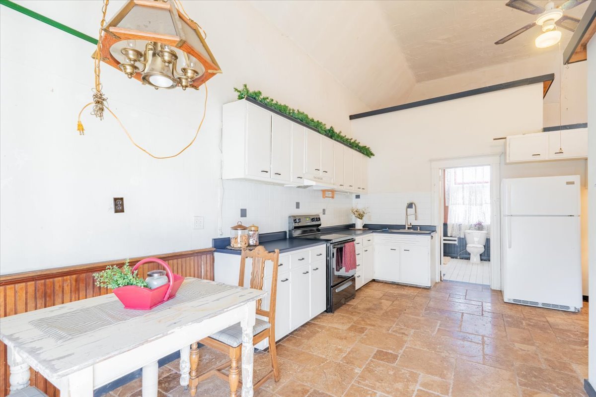 269 Chicago Street Dewitt, IL 61735 - Photo 20 of 34 a kitchen with granite countertop a sink a stove and chairs