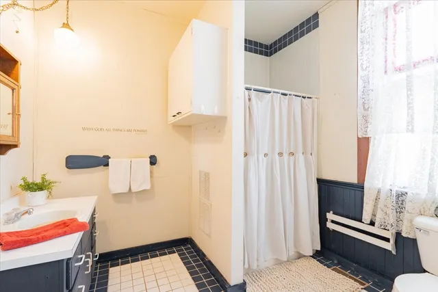 a bathroom with a sink and a shower curtain