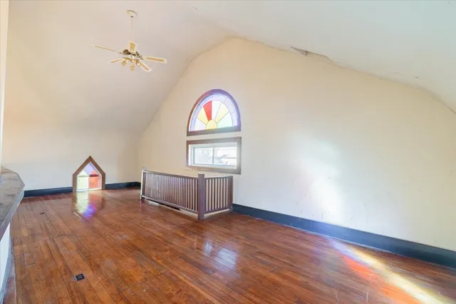 a view of room with window and wooden floor