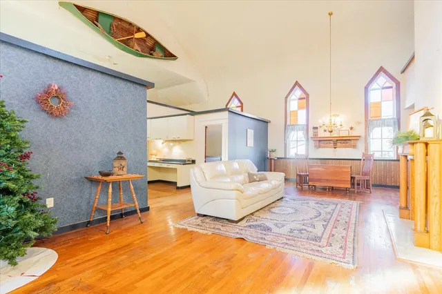 a bedroom with furniture and a large window