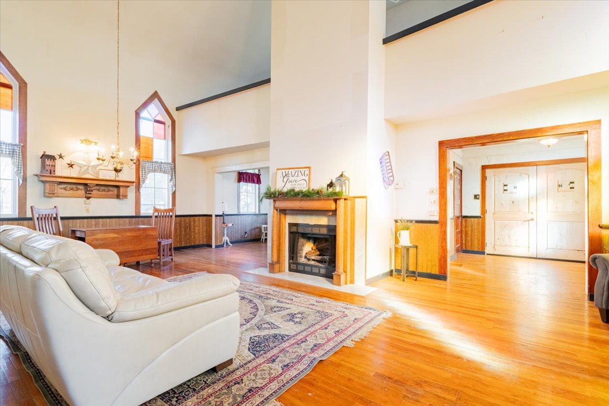 269 Chicago Street Dewitt, IL 61735 - Photo 7 of 34 a living room with furniture a fireplace and a floor to ceiling window