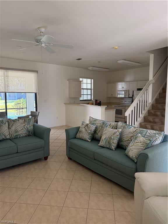 15155 Summit Pl Circle, Unit 232 Naples, FL 34119 - Photo 13 of 27 a living room with furniture and a ceiling fan
