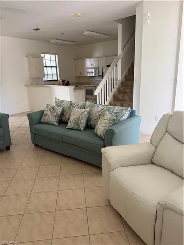 a living room with furniture and stairs