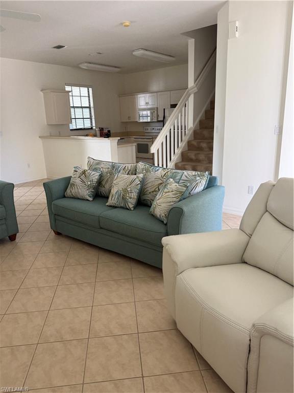 15155 Summit Pl Circle, Unit 232 Naples, FL 34119 - Photo 14 of 27 a living room with furniture and stairs