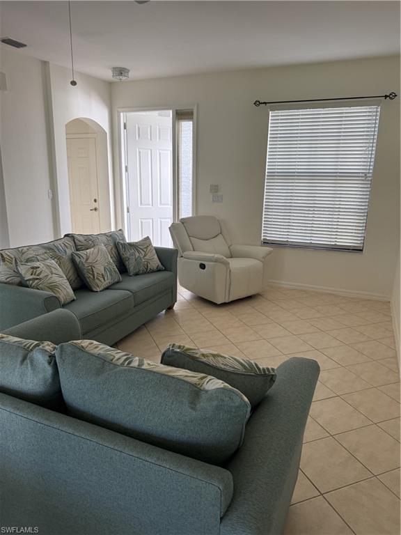 15155 Summit Pl Circle, Unit 232 Naples, FL 34119 - Photo 16 of 27 a living room with furniture and a window