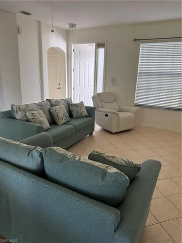 a living room with furniture and a window