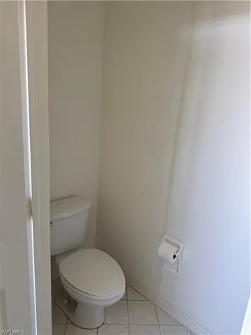 a white toilet sitting next to a shower