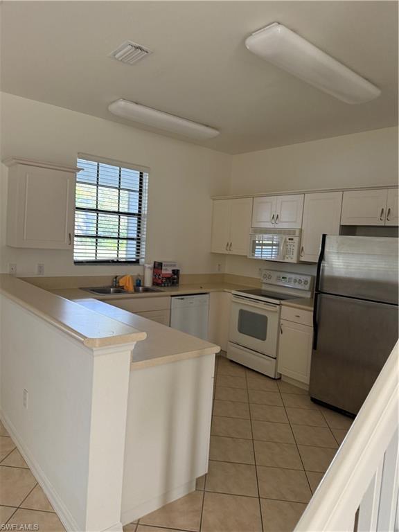 15155 Summit Pl Circle, Unit 232 Naples, FL 34119 - Photo 5 of 27 a kitchen with a stove sink and cabinets