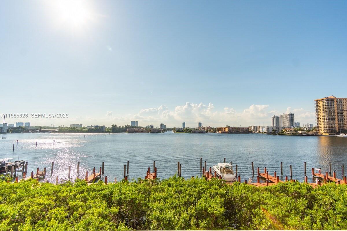a view of a lake with houses in front of it