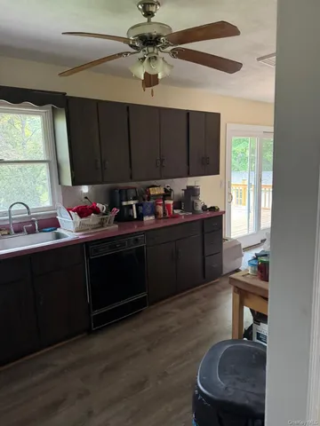 a kitchen with a sink cabinets and window