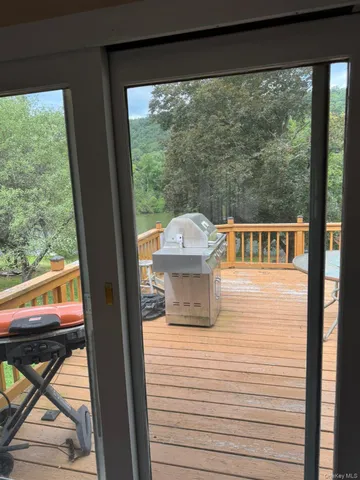 a view of a balcony with chair and wooden floor