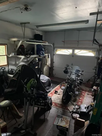 a kitchen with a table chairs and flat screen tv