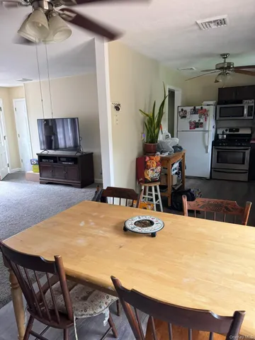 a view of a roof deck with chair and wooden floor