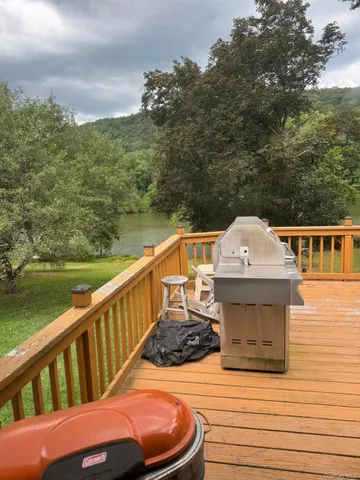 a view of a balcony with chair and wooden floor