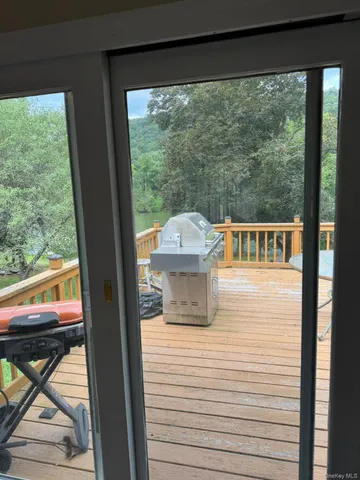 a balcony with wooden floor table and chairs