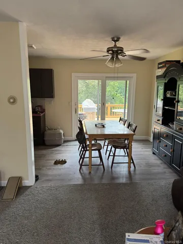 a view of a livingroom with furniture window and a wooden floor