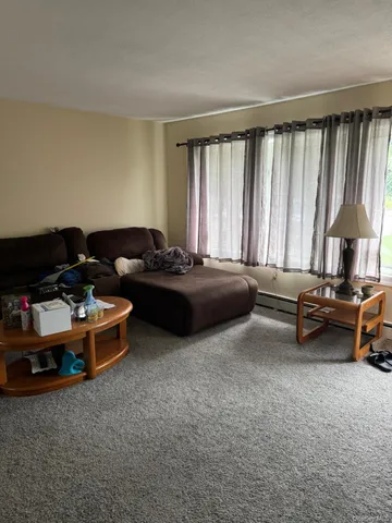 a view of a room with floor to ceiling window and a living room