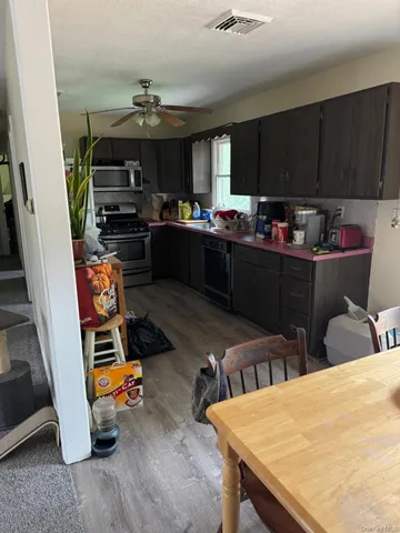 a kitchen with a table chairs and a refrigerator