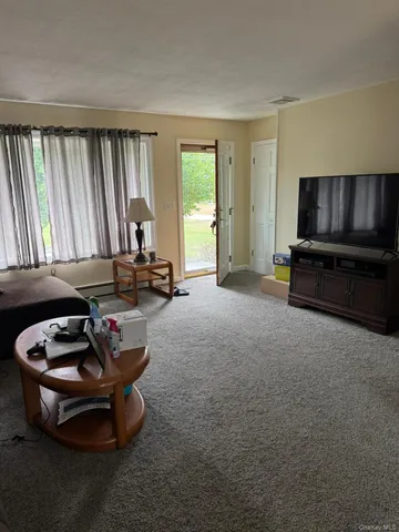 a room with furniture and a flat screen tv