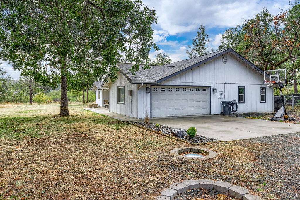 167 Rippling Way Merlin, OR 97532 - Photo 31 of 39 a view of a house with a yard and garage